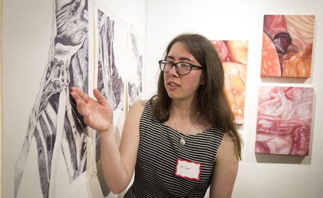 Student showing poster