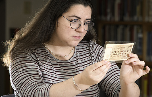 student looking at money
