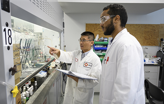 student intern with manager of lab going over equipment