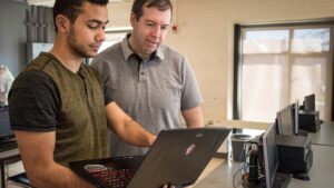 John Magee helping a computer science student on their project