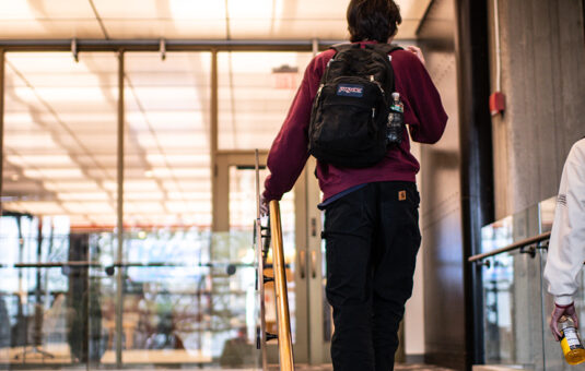 Bachelor's to Master's Program hero with two students walking up stairs in library
