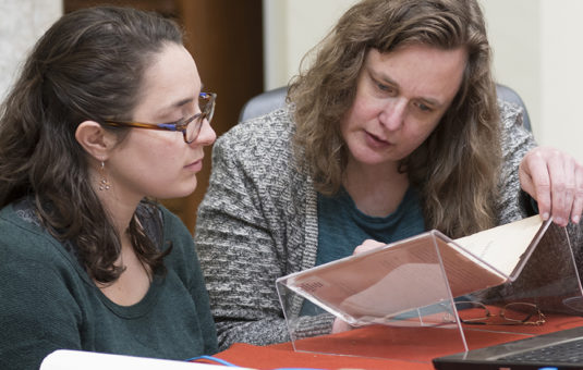 Professor Neuman talking to student